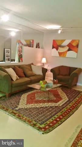 a living room with furniture rug and a table