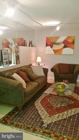 a living room with furniture and a rug