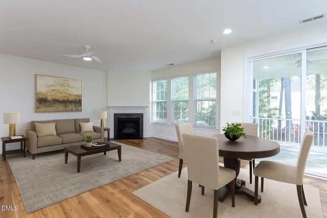 a view of empty room with wooden floor and fireplace