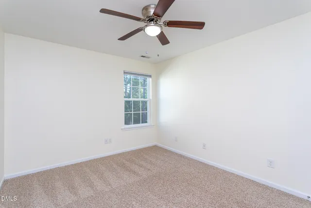 a living room with furniture and a ceiling fan