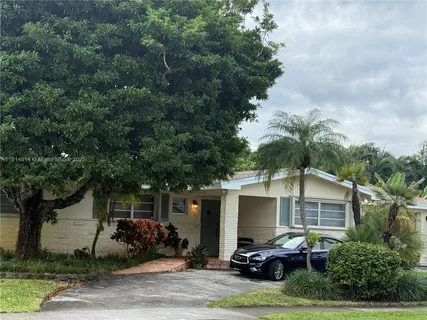 a view of a patio with table and chairs and potted plants