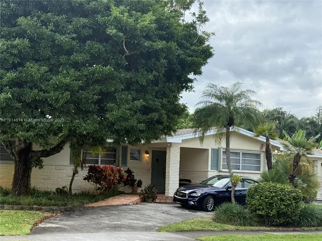 a view of a patio with table and chairs and potted plants
