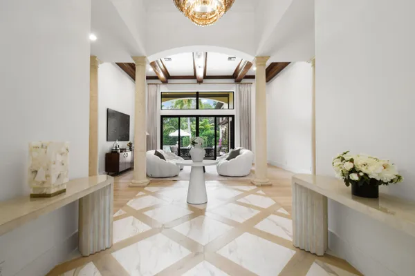a view of a dining room with furniture a chandelier and wooden floor