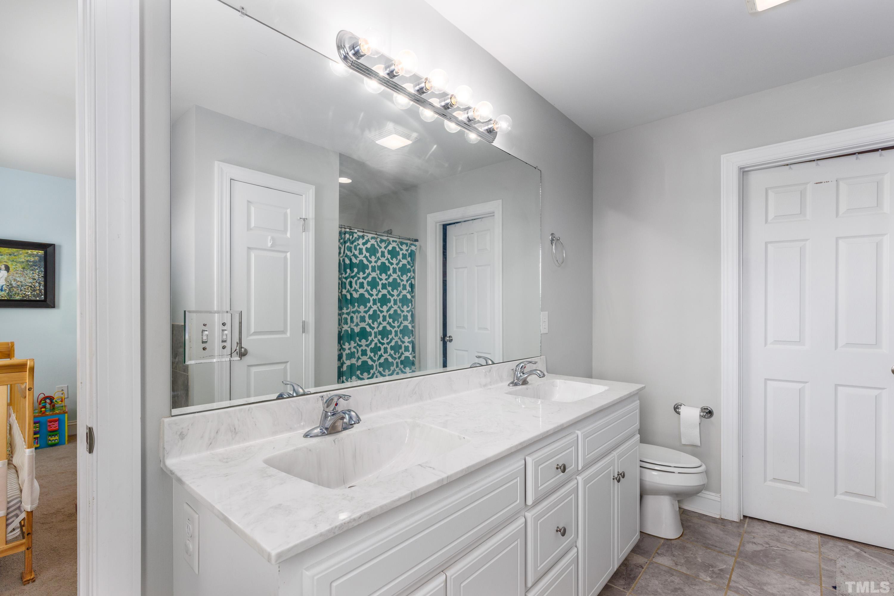 5333 Needham Road Bailey, NC 27807 - Photo 12 of 20 a bathroom with a sink and a large mirror