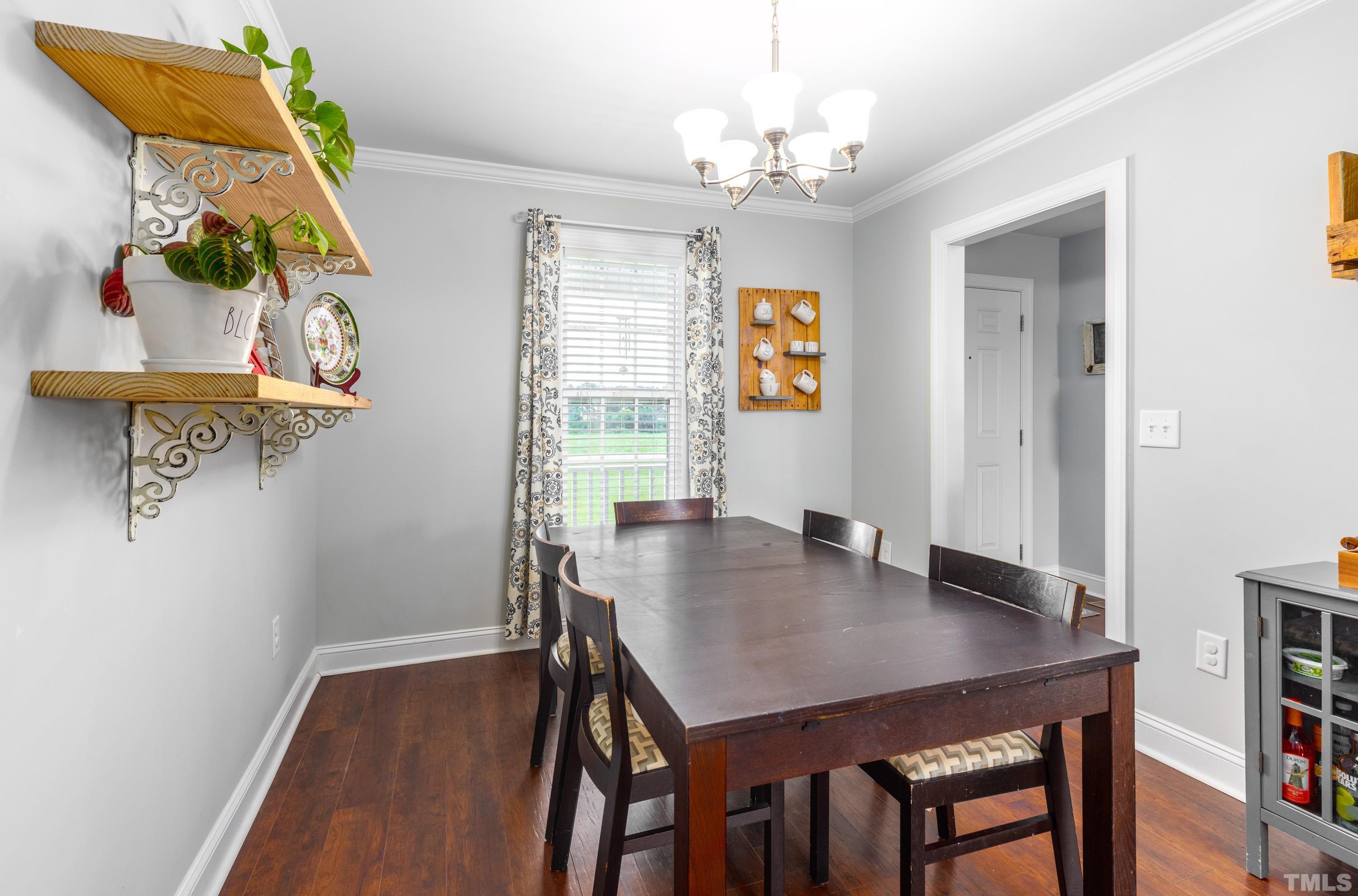 5333 Needham Road Bailey, NC 27807 - Photo 18 of 20 a view of a dining room with furniture and chandelier