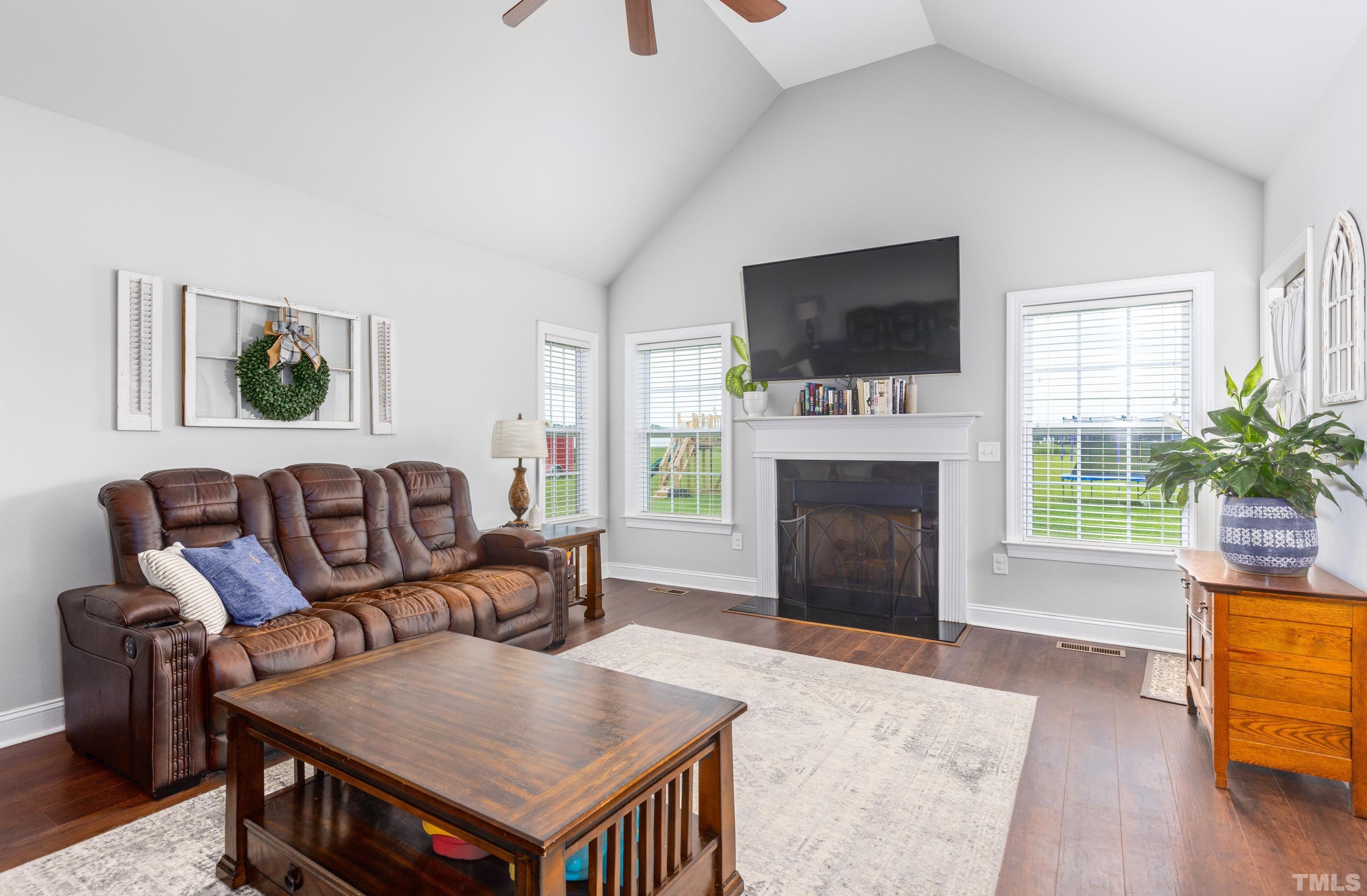 5333 Needham Road Bailey, NC 27807 - Photo 5 of 20 a living room with furniture a flat screen tv and a fireplace