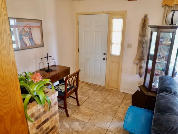 a dining room table with chairs and painting on the wall