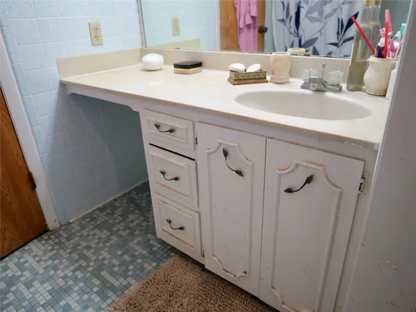 a bedroom with a bed and dresser