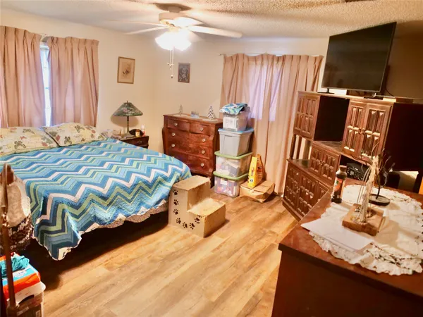 a bedroom with a bed and a television