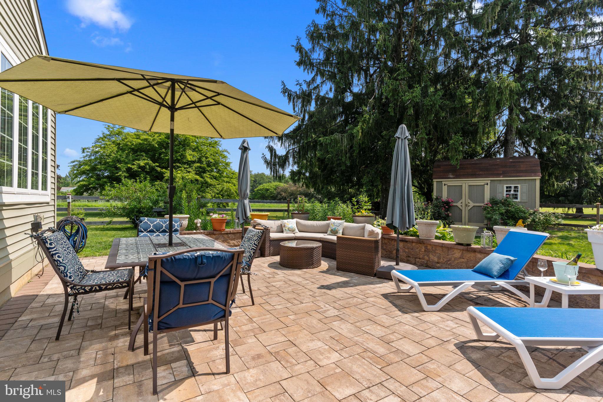 410 Island Road Columbus, NJ 08022 - Photo 34 of 43 a view of an outdoor sitting area with couch and umbrella