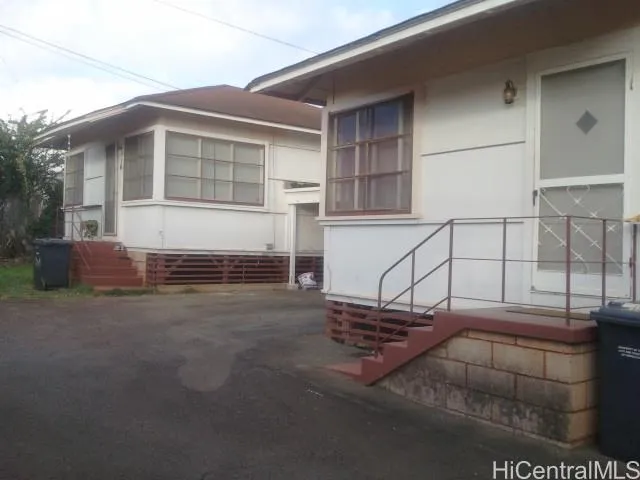 a view of garage with a car parked in it