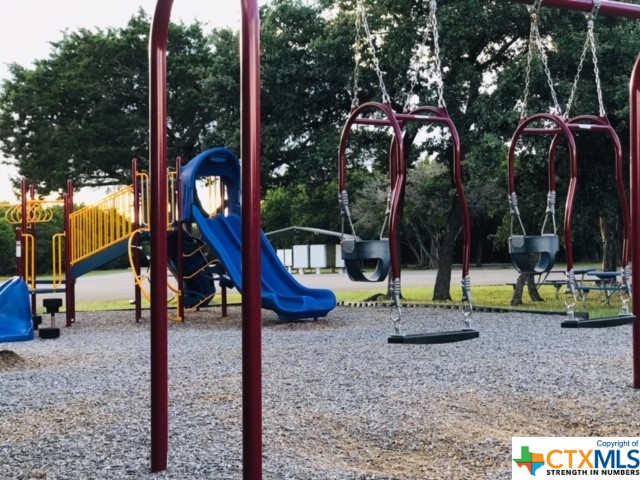 a view of a park with swings and slides