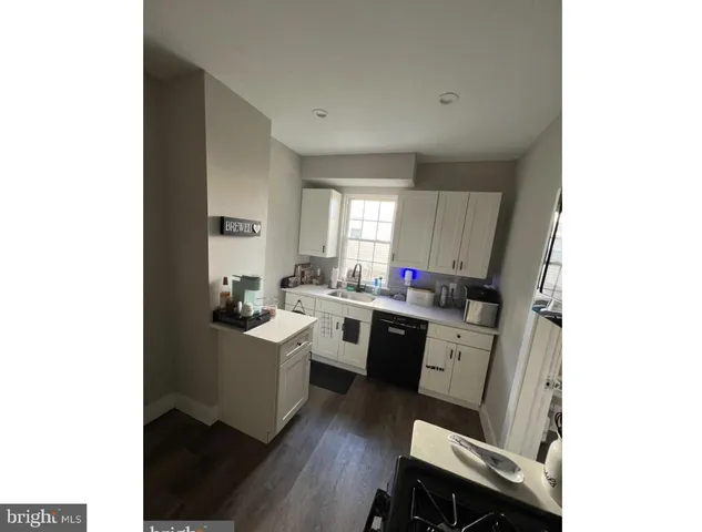 a kitchen with a sink dining table and chairs