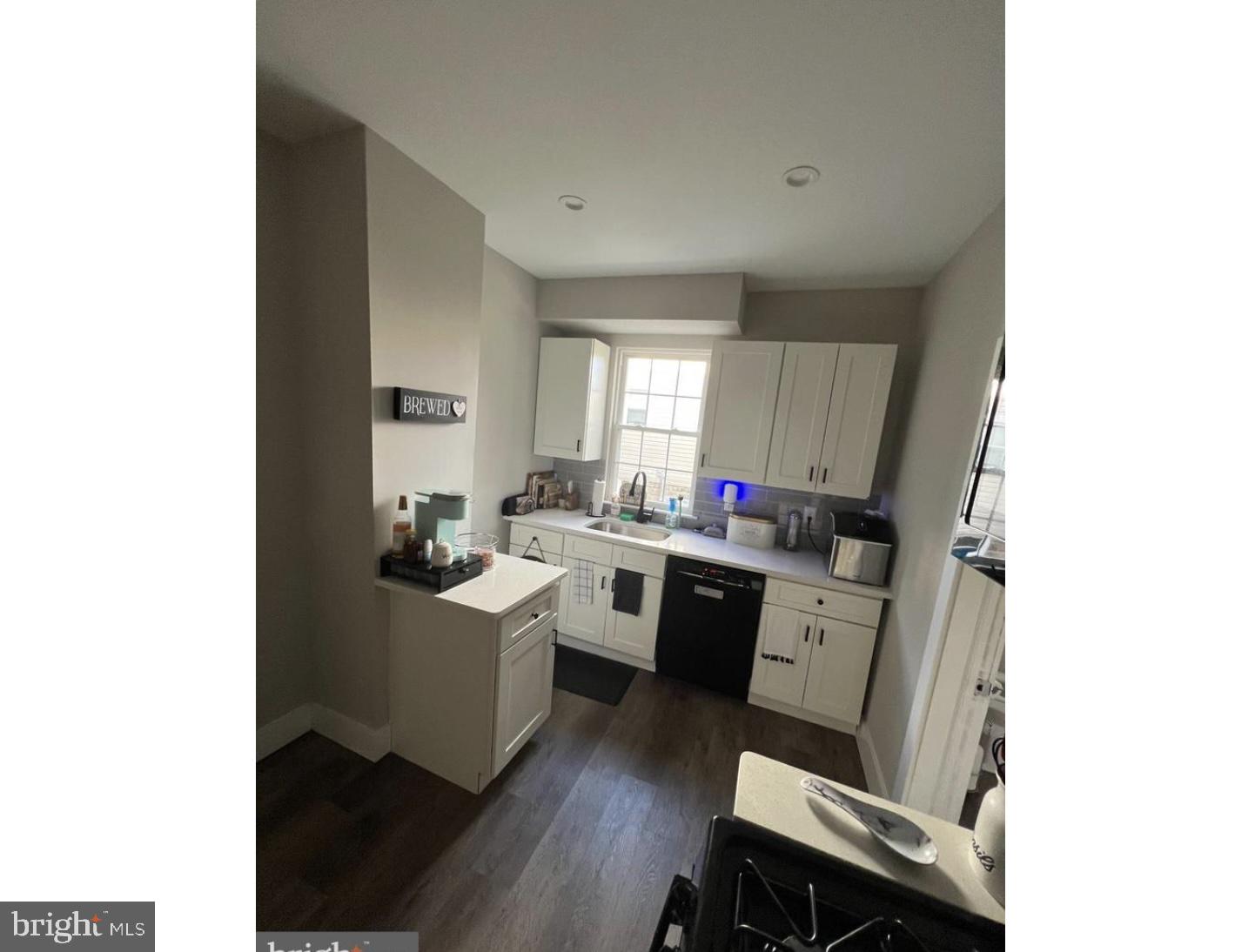 28 Zane Street, Unit 28 Glassboro, NJ 08028 - Photo 7 of 10 a kitchen with a sink dining table and chairs