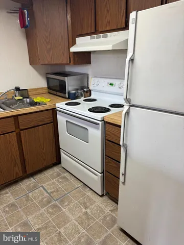 a kitchen with a stove and a refrigerator