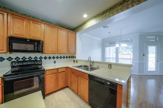 a kitchen with a sink stove top oven and cabinets