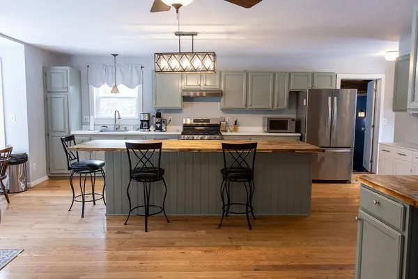 a kitchen with a table and chairs in it