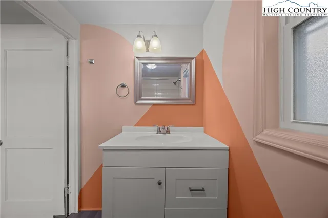 a bathroom with a sink and mirror