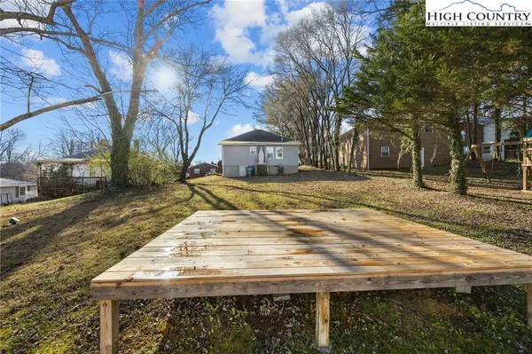 a view of a yard with plants and trees