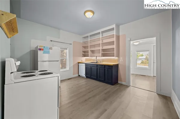 a room with a cabinets and a refrigerator