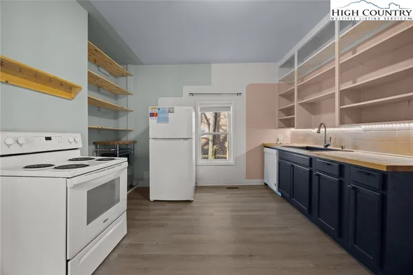a kitchen with a refrigerator stove and sink