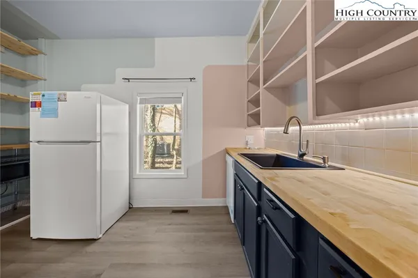 a kitchen with a refrigerator and a sink