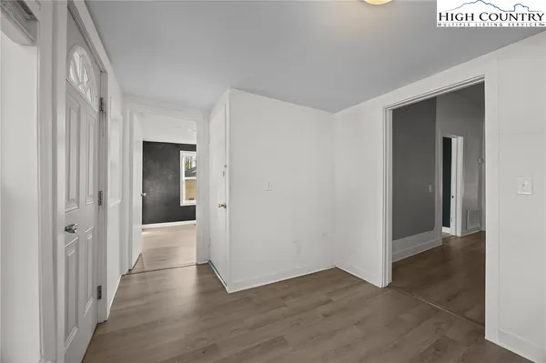 a view of a hallway with wooden floor