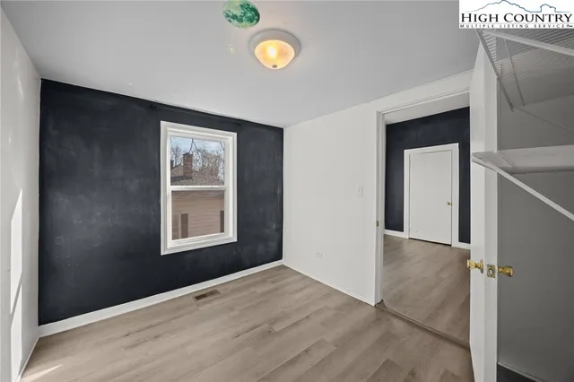 an empty room with windows and entrance