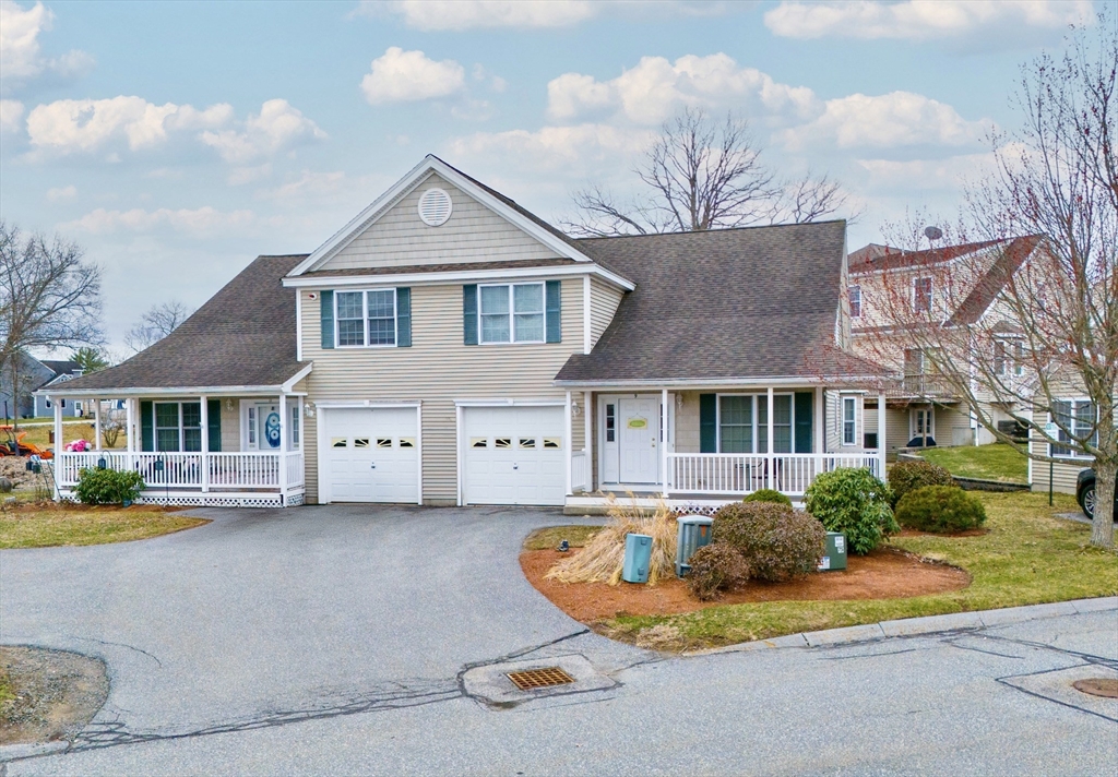 615 Nashua Road, Unit 9 Dracut, MA 01826 - Photo 1 of 38 a front view of a house with a garden and plants