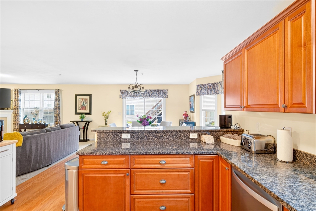 615 Nashua Road, Unit 9 Dracut, MA 01826 - Photo 12 of 38 a kitchen with granite countertop a sink and cabinets