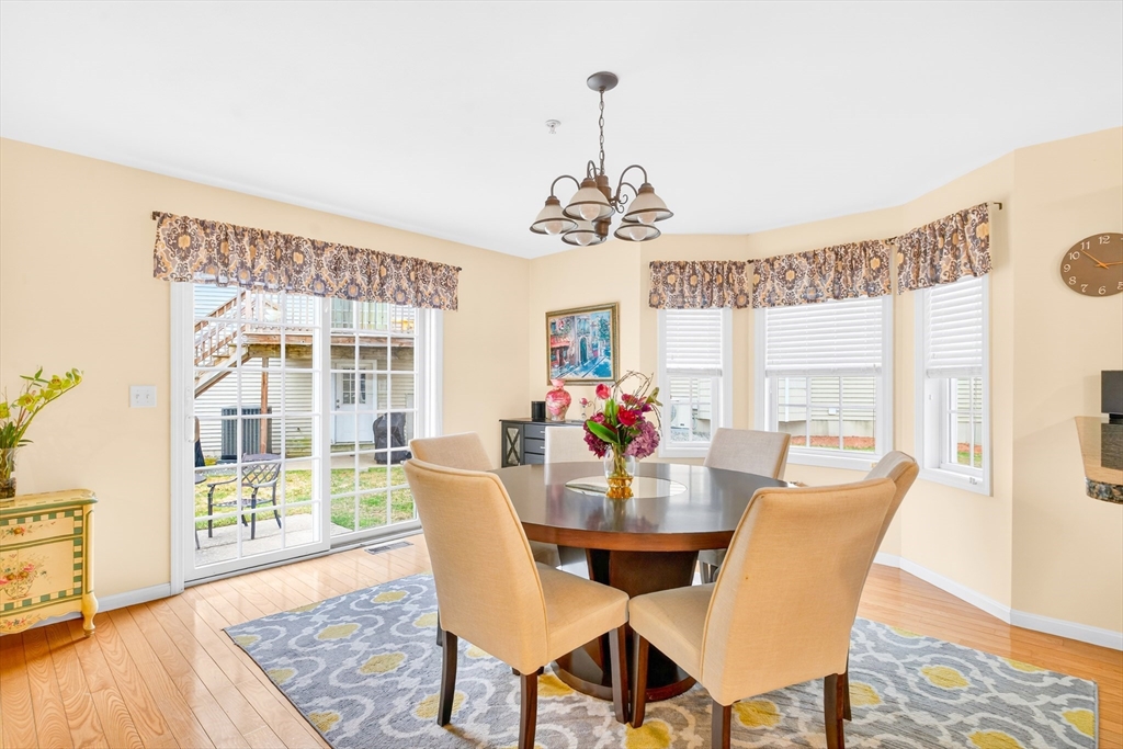 615 Nashua Road, Unit 9 Dracut, MA 01826 - Photo 13 of 38 a view of a dining room with furniture wooden floor and a chandelier