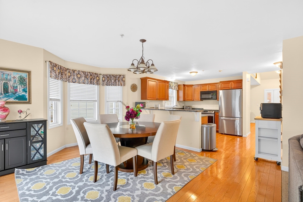 615 Nashua Road, Unit 9 Dracut, MA 01826 - Photo 14 of 38 a view of a dining room with furniture and wooden floor