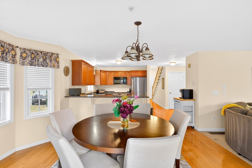 615 Nashua Road, Unit 9 Dracut, MA 01826 - Photo 15 of 38 a dining room with furniture and wooden floor