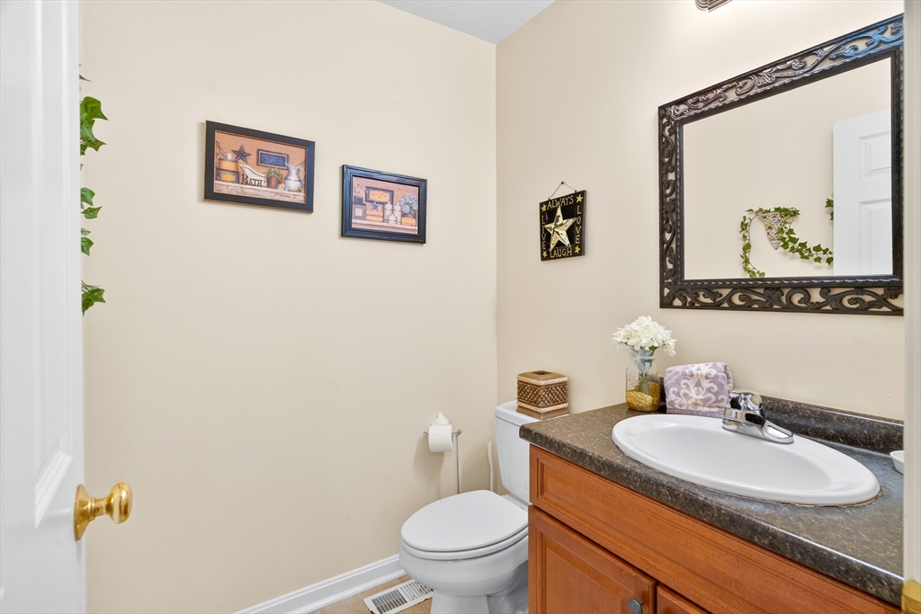 615 Nashua Road, Unit 9 Dracut, MA 01826 - Photo 20 of 38 a bathroom with a toilet a sink and mirror