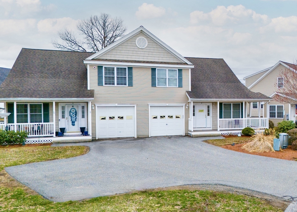 615 Nashua Road, Unit 9 Dracut, MA 01826 - Photo 2 of 38 a front view of a house with swimming pool and porch