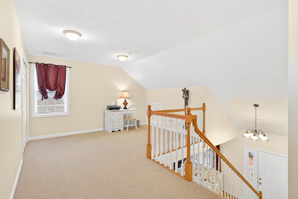 615 Nashua Road, Unit 9 Dracut, MA 01826 - Photo 22 of 38 a view of a hallway with paintings on the walls