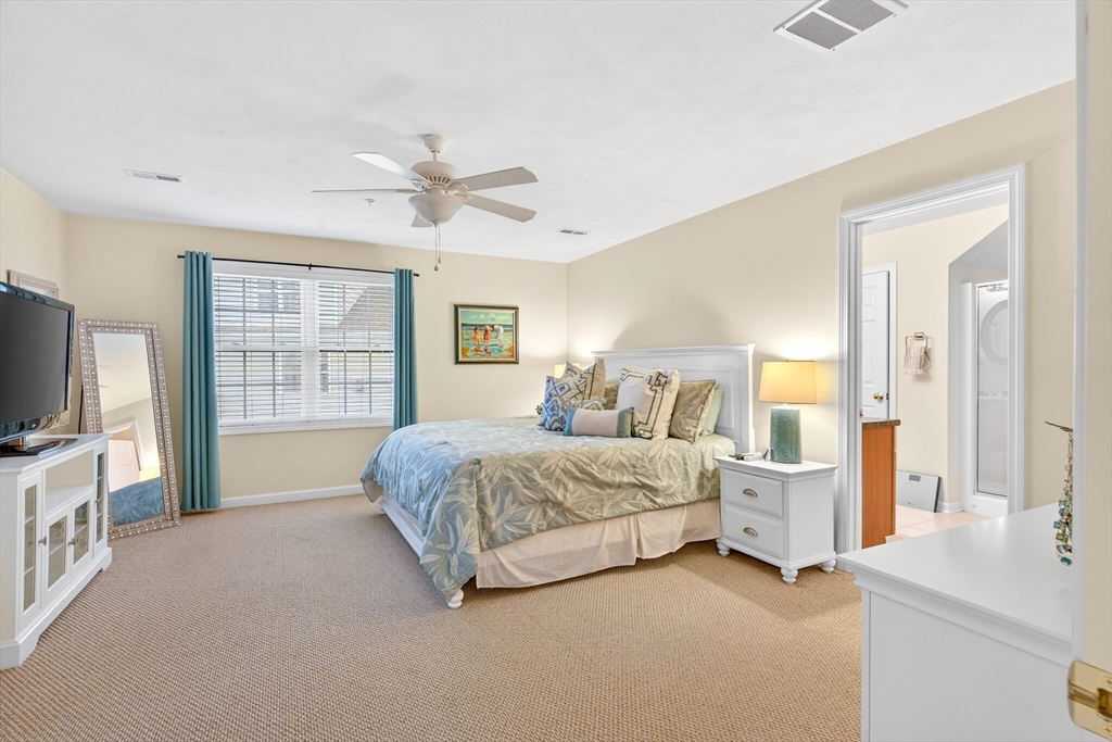 615 Nashua Road, Unit 9 Dracut, MA 01826 - Photo 26 of 38 a spacious bedroom with a bed couch tv and a window