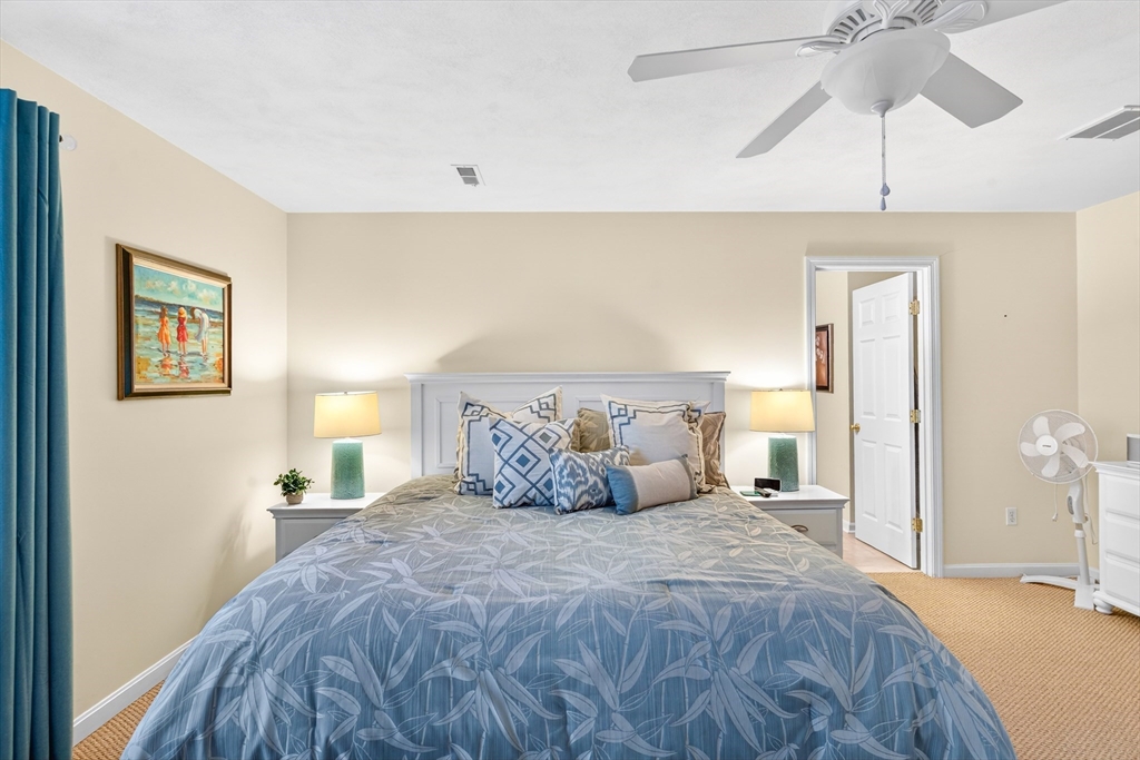 615 Nashua Road, Unit 9 Dracut, MA 01826 - Photo 28 of 38 a bedroom with a bed and a chandelier
