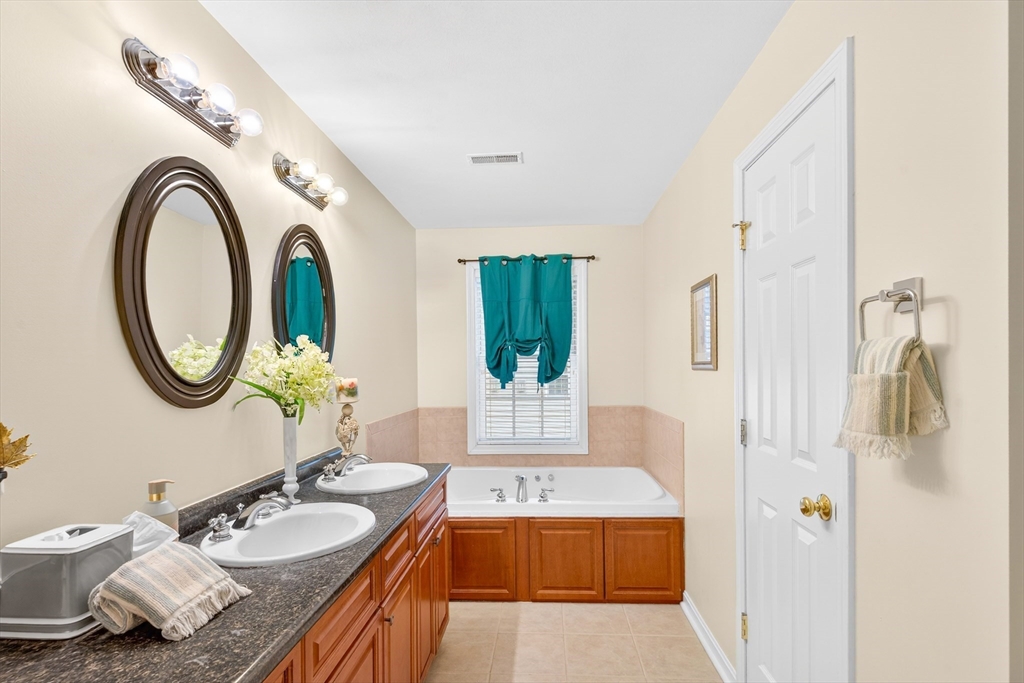 615 Nashua Road, Unit 9 Dracut, MA 01826 - Photo 31 of 38 a bathroom with a granite countertop sink and a mirror