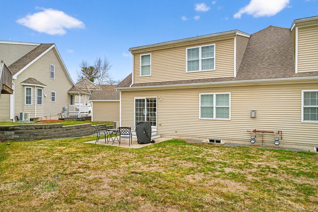 615 Nashua Road, Unit 9 Dracut, MA 01826 - Photo 35 of 38 a view of a house with swimming pool and a yard