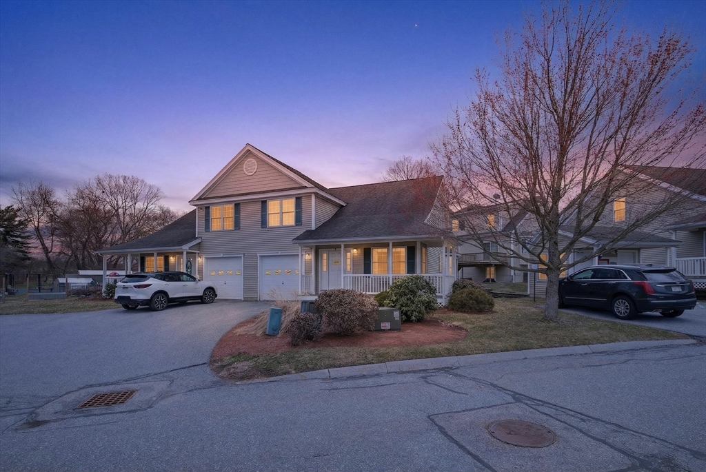 615 Nashua Road, Unit 9 Dracut, MA 01826 - Photo 38 of 38 a front view of a house with a yard and parking space