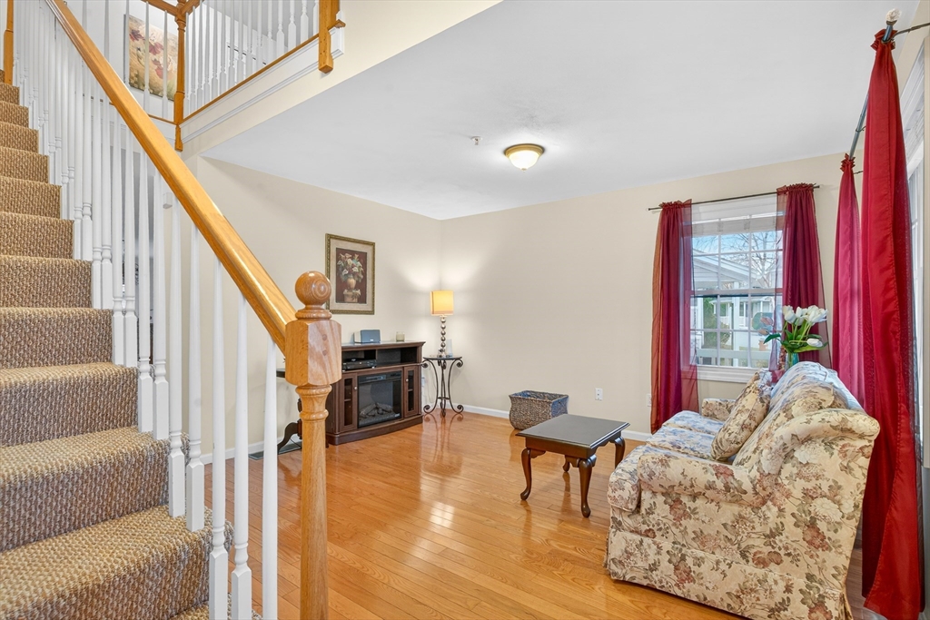 615 Nashua Road, Unit 9 Dracut, MA 01826 - Photo 5 of 38 a living room with furniture and a wooden floor