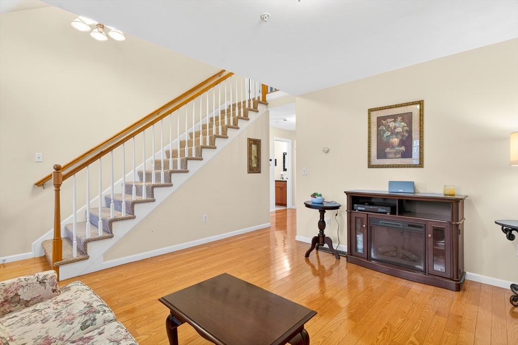 615 Nashua Road, Unit 9 Dracut, MA 01826 - Photo 6 of 38 a view of a livingroom with furniture and hardwood floor