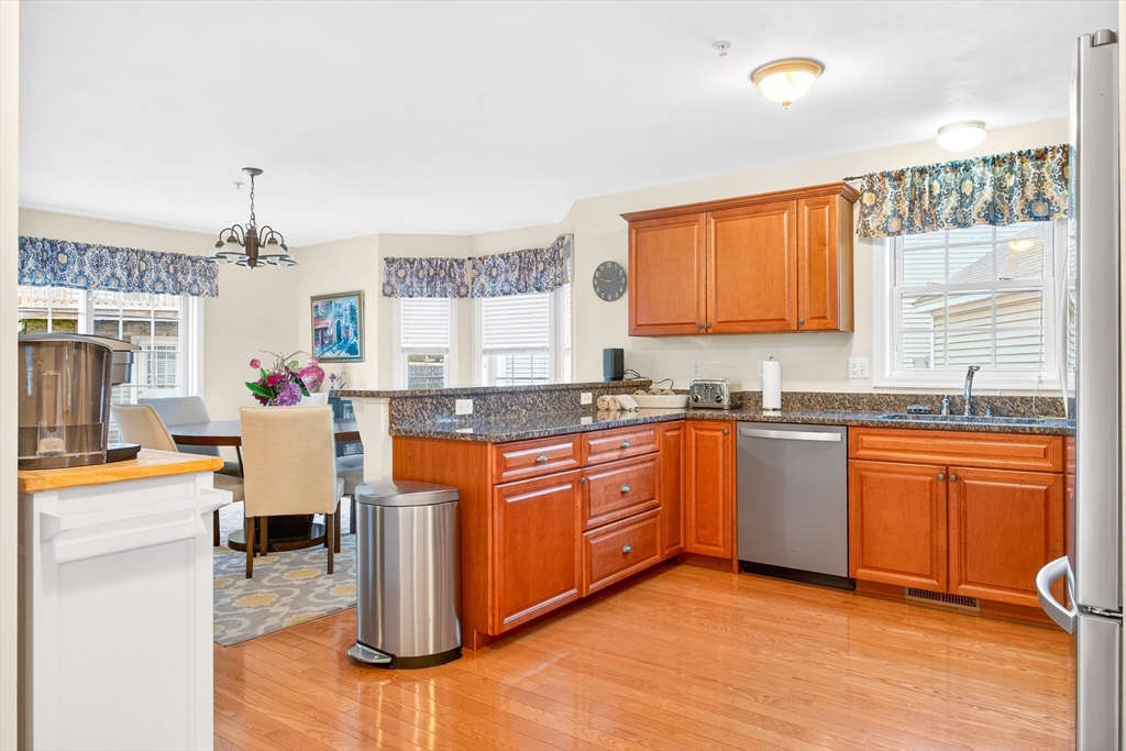 615 Nashua Road, Unit 9 Dracut, MA 01826 - Photo 8 of 38 a kitchen with stainless steel appliances granite countertop a sink stove and refrigerator