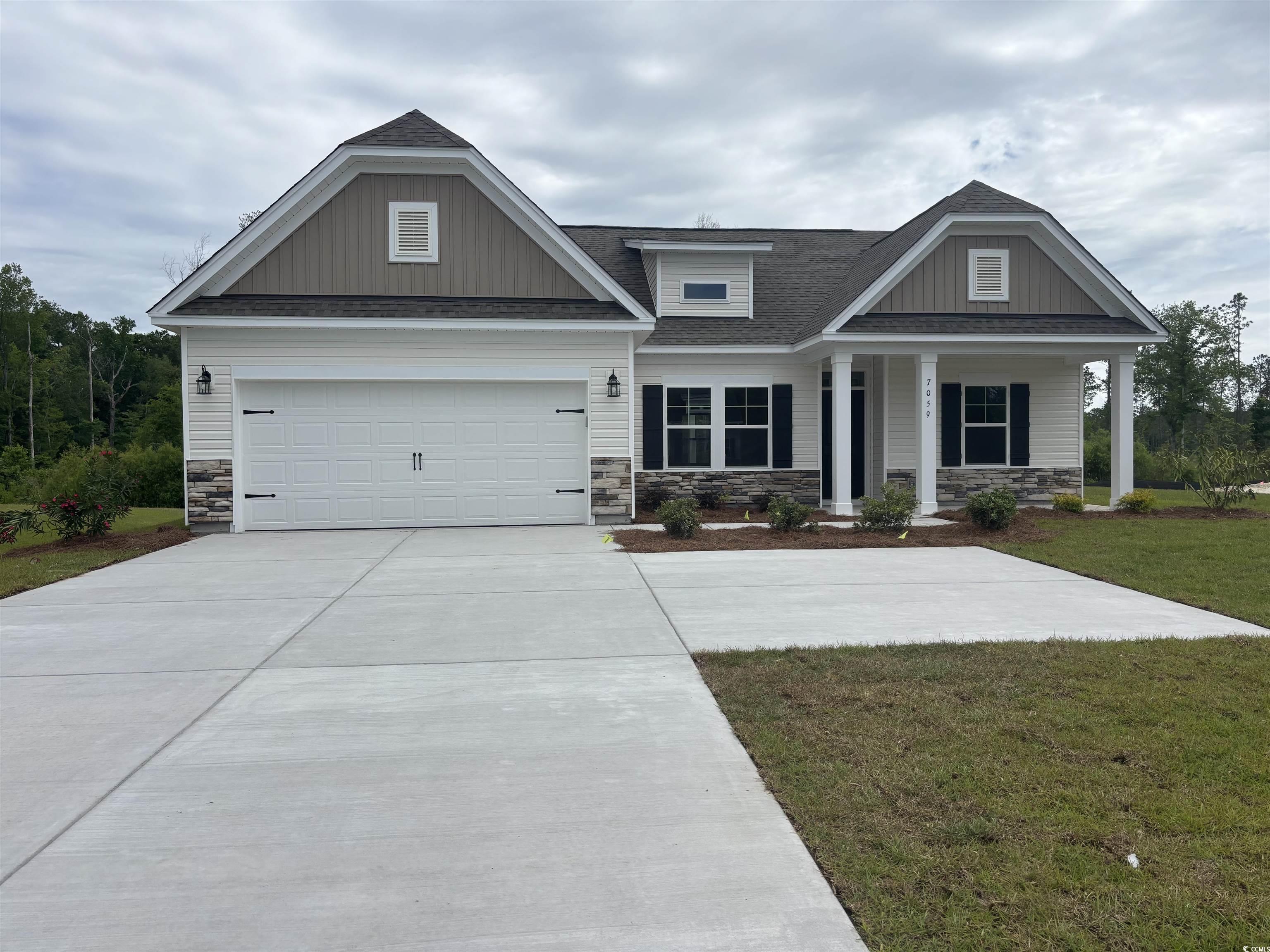 Craftsman-style home with a front lawn, roof with