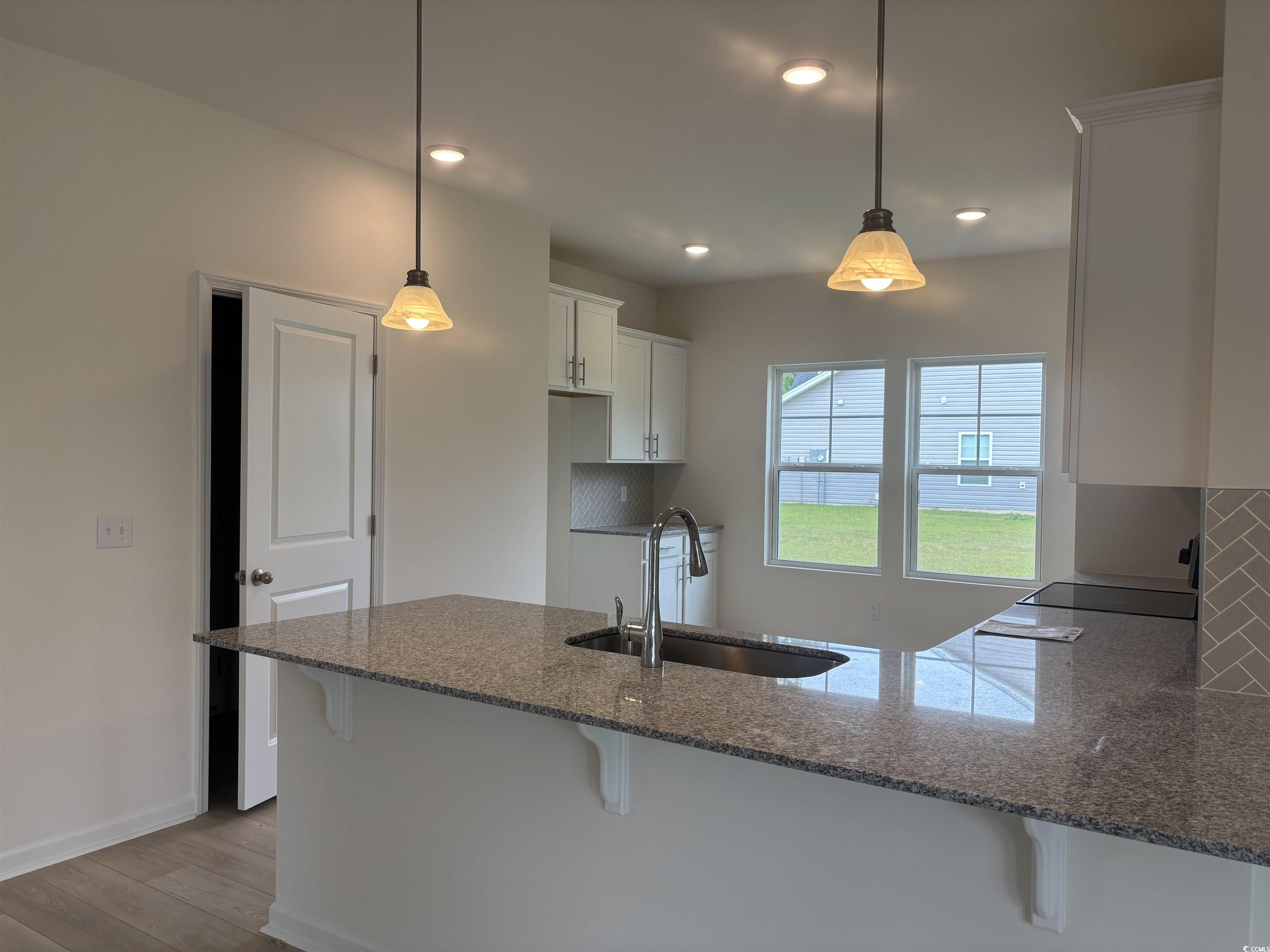 7059 Shady Grove Road Conway, SC 29527 - Photo 10 of 37 Kitchen featuring a peninsula, a kitchen bar, dark