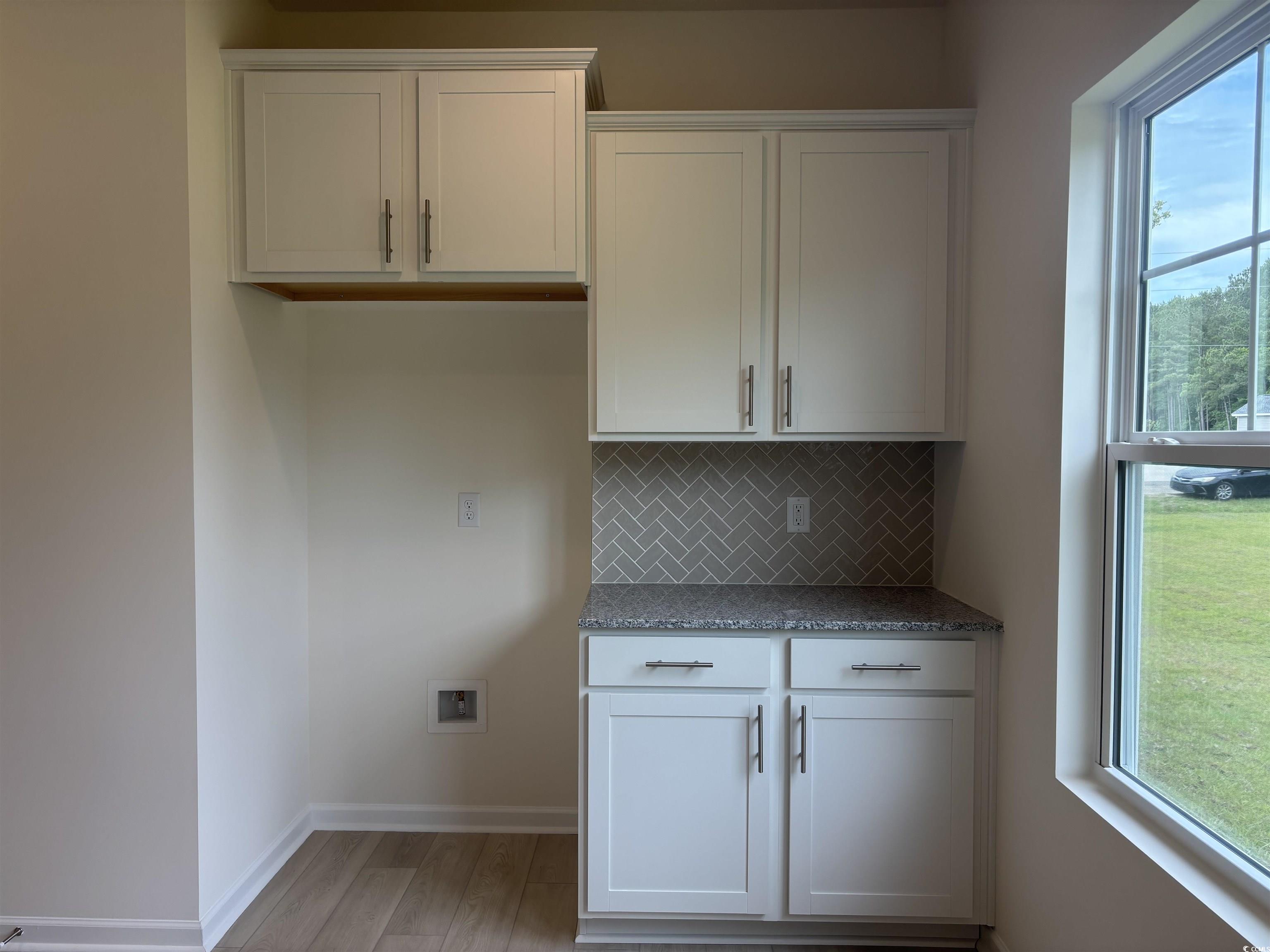 7059 Shady Grove Road Conway, SC 29527 - Photo 12 of 37 Kitchen with baseboards, backsplash, light wood fi
