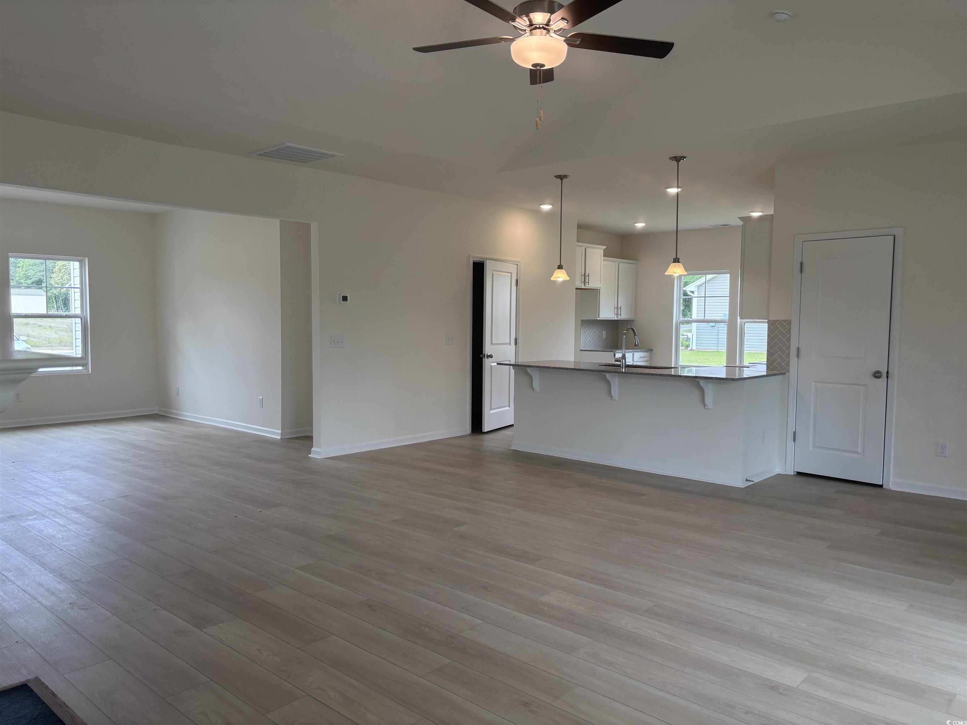 7059 Shady Grove Road Conway, SC 29527 - Photo 15 of 37 Unfurnished living room with a ceiling fan, a sink