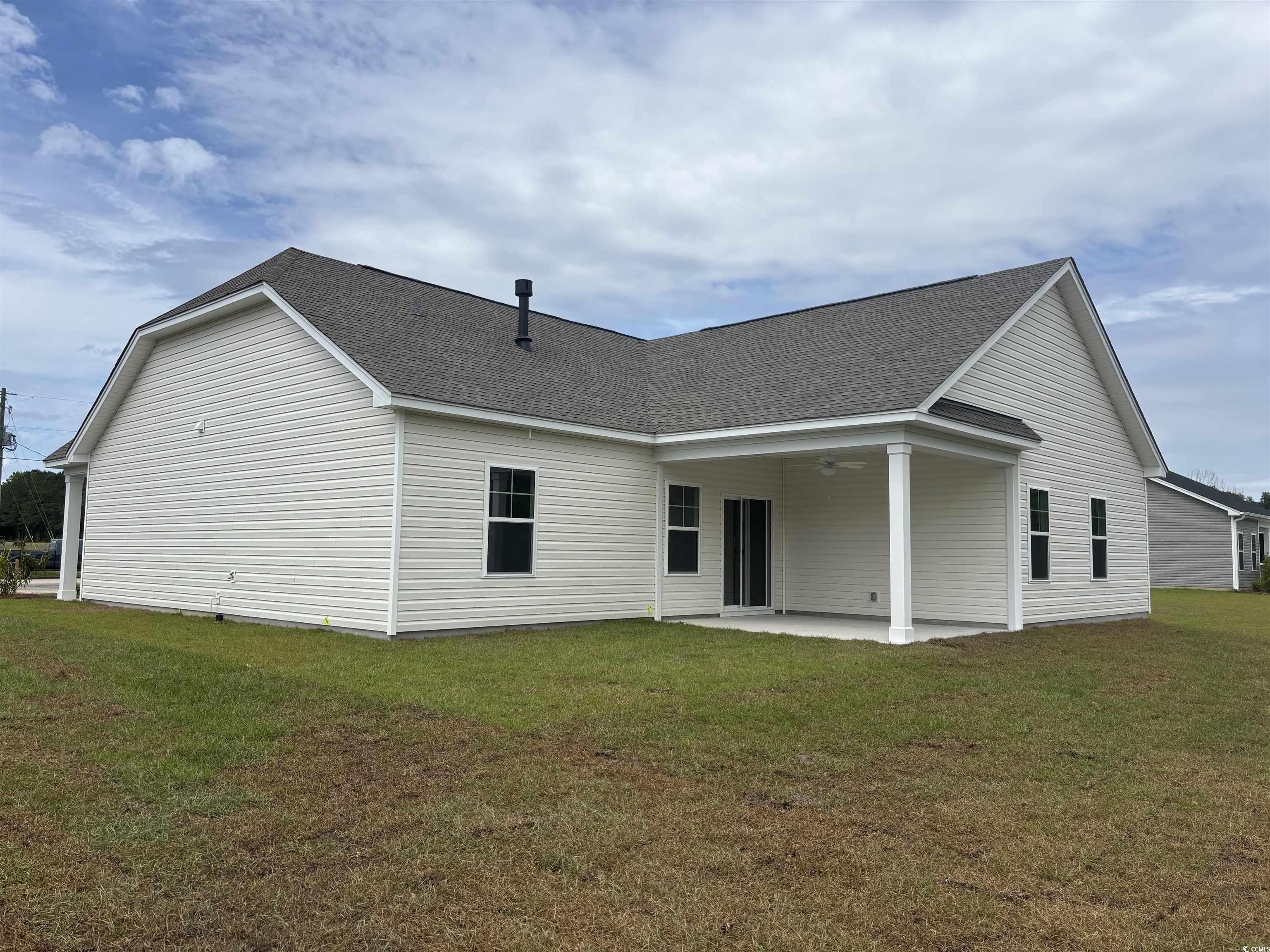 7059 Shady Grove Road Conway, SC 29527 - Photo 6 of 37 Back of property with a lawn, a patio, and roof wi