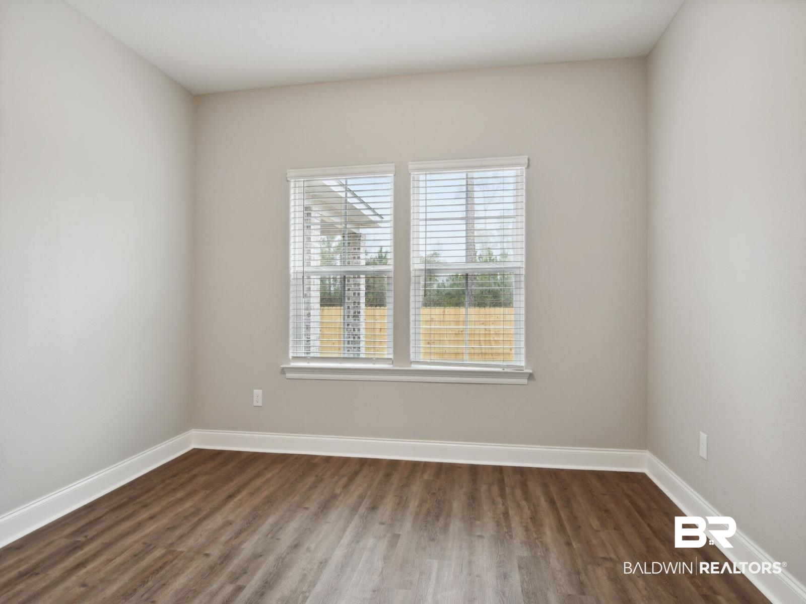 12942 Gondala Street Elberta, AL 36530 - Photo 15 of 18 Unfurnished room with dark wood-type flooring and baseboards